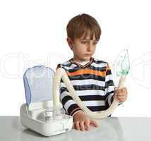 little boy makes inhalation with nebuliser