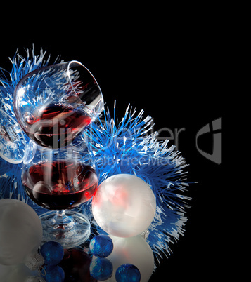 Glasses of wine, tangerine and chocolate and Santa Claus hat on a black background