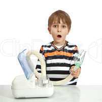 little boy makes inhalation with nebuliser