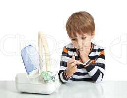 The boy looks at the thermometer. Isolate on white background