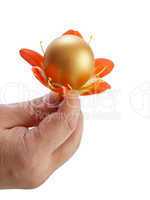 Golden Egg in a man's hand with flower