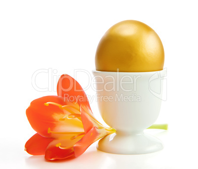 The golden egg with a flower . Isolate on white.