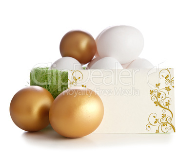 Gold and simple eggs with an invitation card.