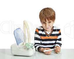 The boy looks at the thermometer. Isolate on white background