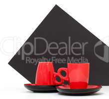 Red coffee cups on a black background
