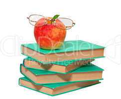 stack of books with an apple and glasses on a white background