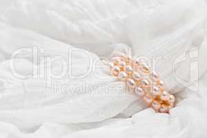 Pink pearls on a white background. Wedding backgrounds.