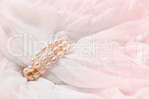 Pink pearls on a Pink  background. Wedding backgrounds.