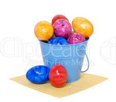 Easter eggs in a bucket on a white background
