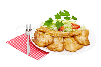 Fried fish fillets with egg and salad.