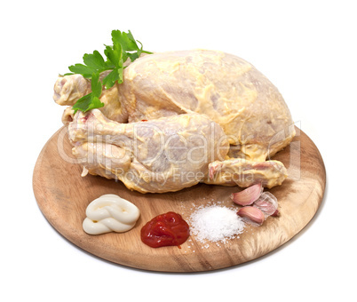 Raw chicken in the marinade on a white background