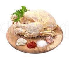 Raw chicken in the marinade on a white background