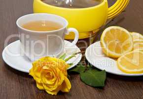 Tea with lemon and yellow rose.