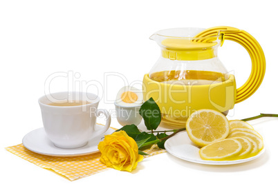 Tea with lemon and yellow roses on a white background