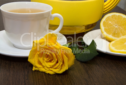Tea with lemon and yellow rose.