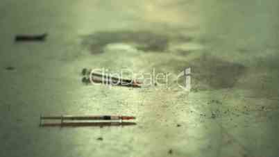 Syringes used for heroin and drugs on dirty floor