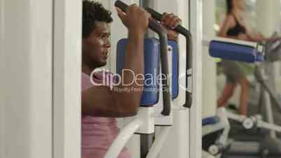 Young african american man training in fitness gym