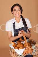 Happy woman carrying fresh croissants