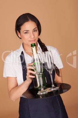 Beautiful waitress serving champagne