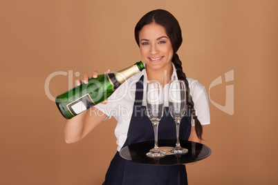 Beautiful waitress pouring champagne
