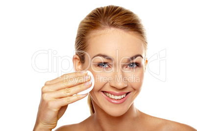 Woman cleaning her face