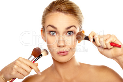 Humorous image of woman with makeup brushes