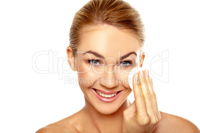 Beautiful woman cleansing her face