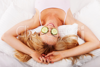 Woman using cucumber eyepads