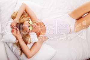 Woman with cucumber eye mask