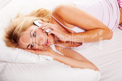 Woman in bed on her mobile