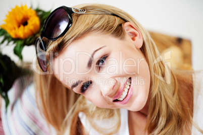 Smiling woman with sunglasses on her hair
