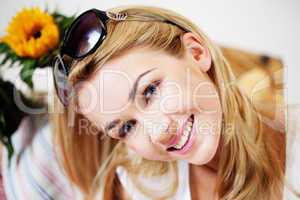 Smiling woman with sunglasses on her hair