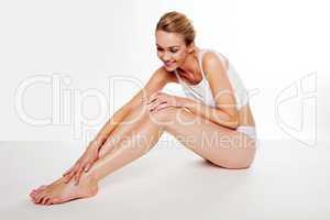 Beautiful woman caressing her legs