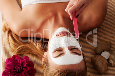 Beautiful woman having a face mask