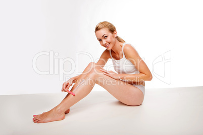 Sexy woman waxing her legs