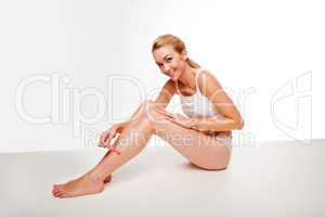 Sexy woman waxing her legs