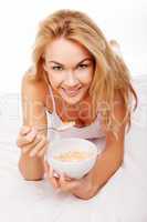 Healthy woman eating breakfast cereal