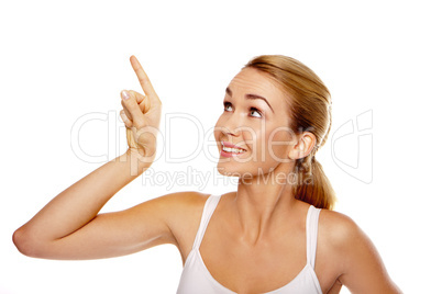 Excited woman pointing above her head