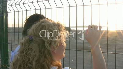 Mother and son standing at the fence