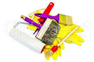 Brushes of various sizes with yellow gloves and roller