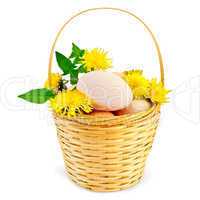 Eggs in a basket with dandelions