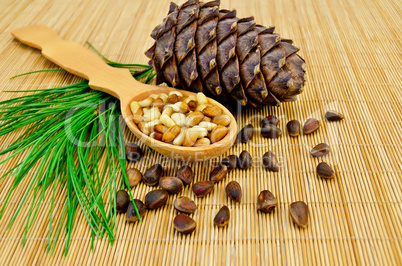 Nuts and cone of cedar on a bamboo mat