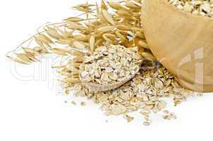 Oat flakes in a bowl and spoon