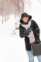 Woman holding gas can winter car breakdown