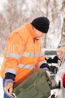 Man filling woman car gas winter assistance
