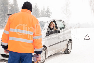 Man helping woman car breakdown assistance snow