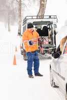 Man helping woman with broken car snow