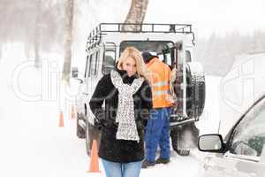 Mechanic helping woman with broken car snow