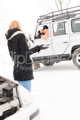 Woman having trouble with car snow assistance