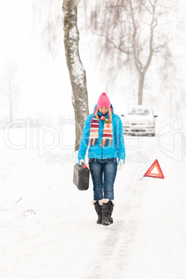 Woman carrying gas can snow car trouble